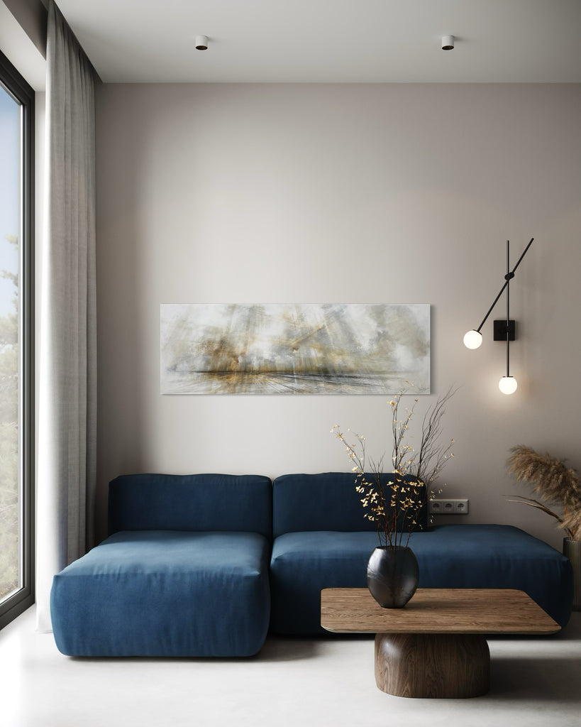 Modern living room with a blue sofa, wooden coffee table, and abstract painting on the wall.