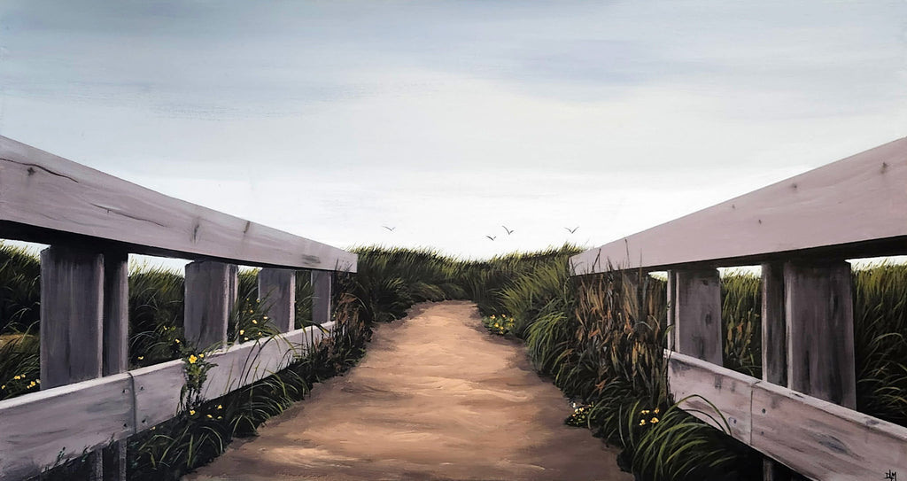 Wooden walkway with railings leading into a natural landscape