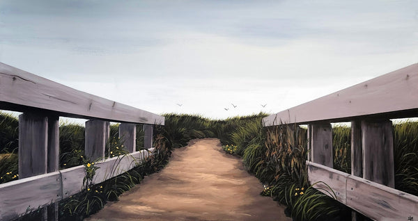 Wooden walkway with railings leading into a natural landscape