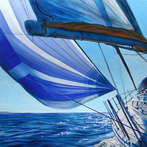 Sailboat with blue and white striped sail on a clear day