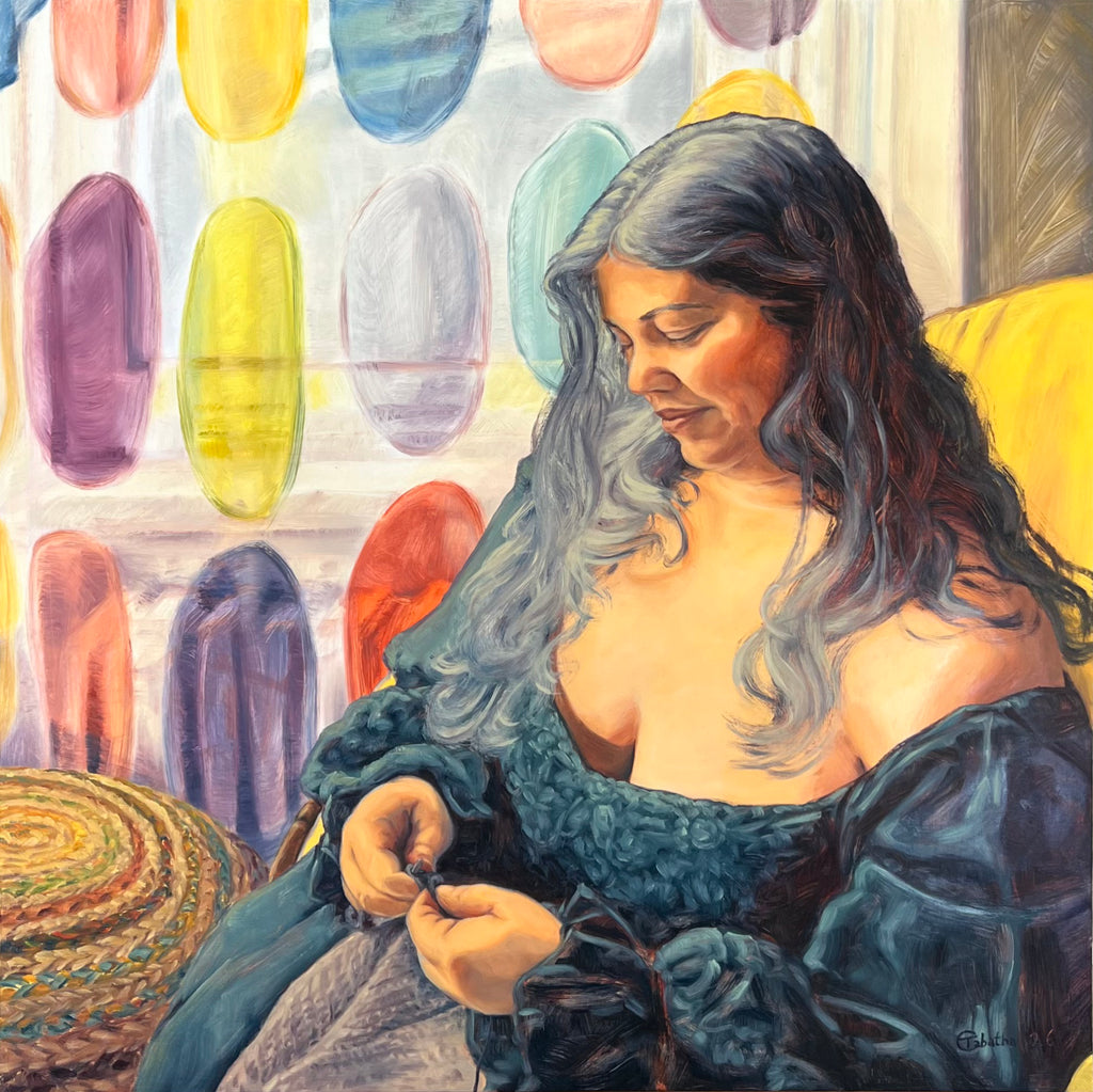 Woman knitting with colorful yarn in the background