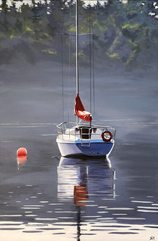 Sailboat with a red flag on a calm lake surrounded by trees