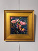 Framed painting of pink flowers on a white wall