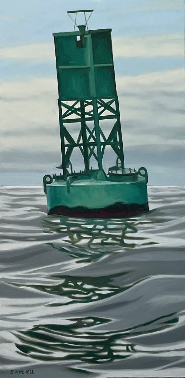 Green buoy floating on water with a clear sky background