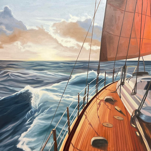 Sailing boat on choppy waters with clouds in the background