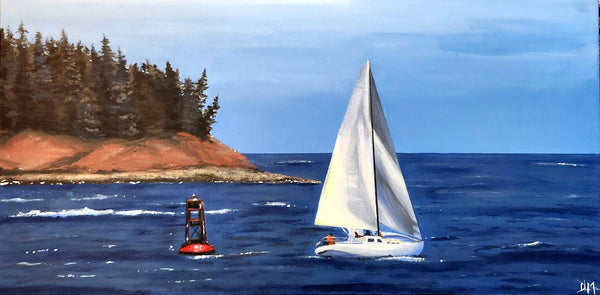 Sailboat on the water near a forested island with a clear sky.