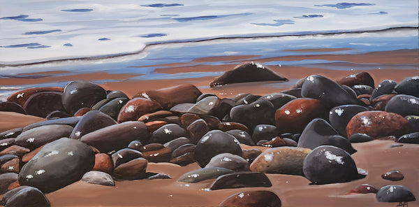 Painting of pebbles on a beach with water in the background